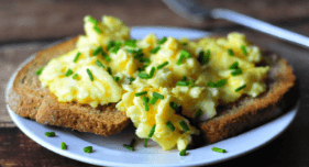 Scrambled eggs with wholemeal toast on a plate.